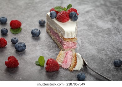 Delicious Raspberry Cake With Cream And Decorated With Fresh Raspberry Berries And Mint Leaves. Fork Break Off Part Of The Cake