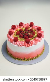 Delicious Raspberry Fruit Ombre Cake and Pistachio Freshcream Pink Gradient Layer Cake Topped and Fresh Fruits Angle View
