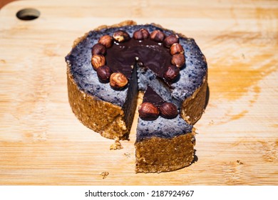 Delicious Raw Blueberry Cake Decorated With Hazelnuts And Chocolate On The Bamboo Board. Almond Flour Base Cake. Cake Slice.
Gluten-free, Dairy-free, Sugar-free, Vegan. Berry Mix Cake. Above View.