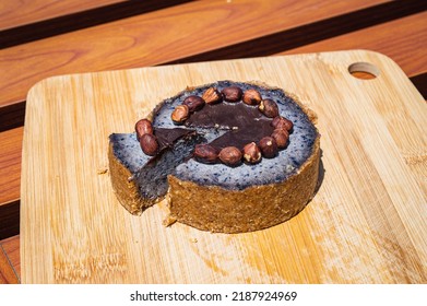 Delicious Raw Blueberry Cake Decorated With Hazelnuts And Chocolate On The Bamboo Board. Almond Flour Base Cake. Cake Slice.
Gluten-free, Dairy-free, Sugar-free, Vegan. Berry Mix Cake. Above View.