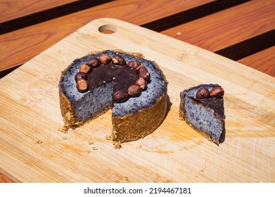 Delicious Raw Blueberry Cake Decorated With Hazelnuts And Chocolate On The Bamboo Board. Almond Flour Base Cake. Cake Slice.
Gluten-free, Dairy-free, Sugar-free, Vegan. Berry Mix Cake. Above View.