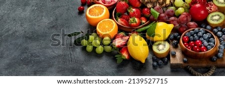 Delicious raw fruit on dark background. Healthy food concept. panorama, copy space