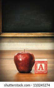 Delicious Red Apple On Old School Desk