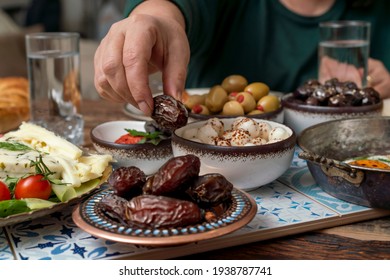 Delicious rich Traditional Turkish breakfast include tomatoes, cucumbers, cheese, butter, eggs, honey, bread, bagels, olives and tea cups. Ramadan Suhoor aka Sahur (morning meal before fasting).  - Shutterstock ID 1938787741