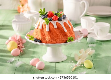 Delicious ring cake for Easter accompanied by eggs and willows. Bundt cake as Babka for Easter.