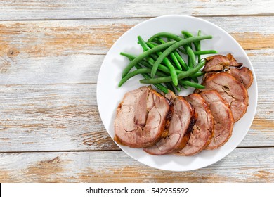 Delicious Roast In Oven Turkey Roulade Cut In Slices With Boiled Green Beans, View From Above