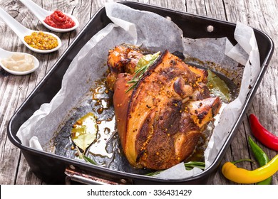 Delicious Roast Pork Knuckle With Rosemary, Pepper, Garlic, Mustard And Spices In The Baking Dish, View From Above