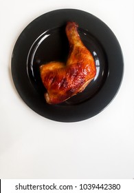 Delicious Roasted Chicken Leg Quarters With Crispy Golden Brown Skin On Black Plate