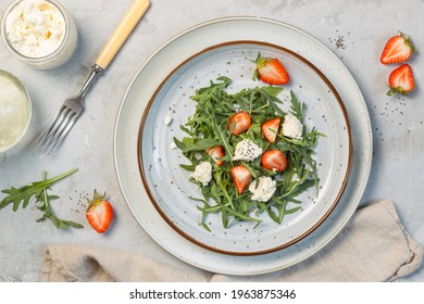 Delicious Salad With Arugula Leaves, Fresh Strawberries, Ricotta And Chia Seeds. Overhead, On A Gray Background, Horizontal