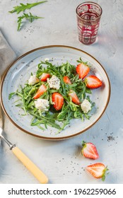 Delicious Salad With Arugula, Strawberries, Ricotta And Chia Seeds. Overhead, On A Gray Background, Vertical Frame