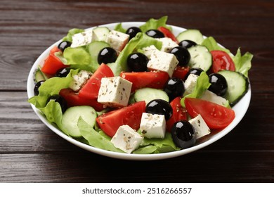 Delicious salad with feta cheese on wooden table, closeup - Powered by Shutterstock