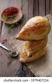 Delicious Samsa With Lamb And Spices Cooked In Tandoor On Wooden Background. Uzbek And Central Asia Cuisine Concept