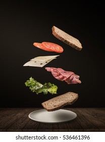 Delicious Sandwich With Floating Ingredients On The Wood Table Black Background