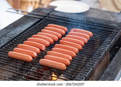 delicious sausages are grilled on a barbecue outside in winter