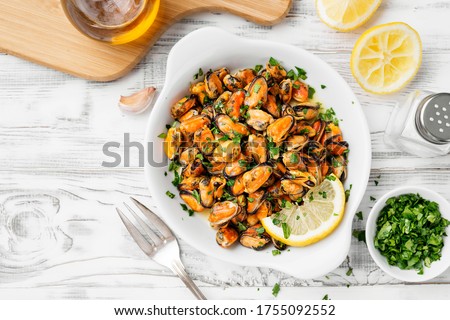 Delicious seafood mussels with lemon and parsley.