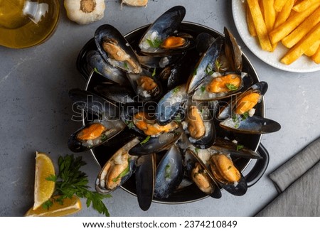 Delicious seafood mussels with parsley sauce and lemon. Delicious steamed mussels.
