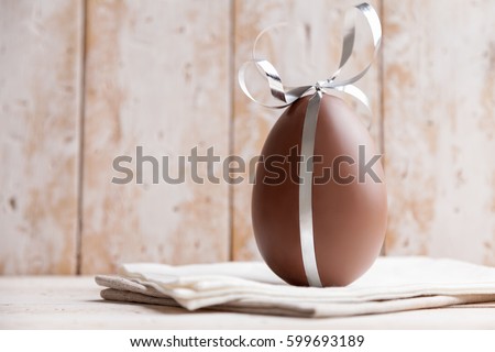 Delicious seasonal chocolate Easter egg with a ribbon