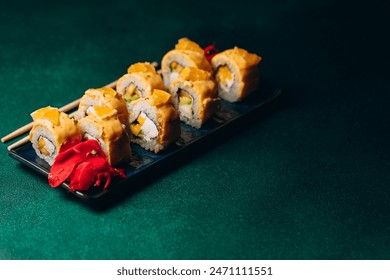 Delicious set of sushi with cheese, fish, shrimp and avocado on a green background - Powered by Shutterstock