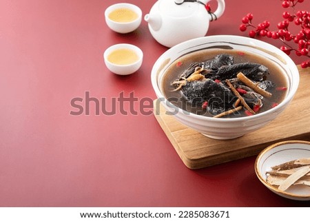 Delicious silky chicken, black-boned chicken soup with Chinese herbal medicine with Chinese word meaning good fortune.