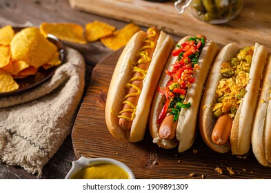 Delicious and simple hot dogs with mustard, pepper, onion and nachos