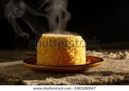 Delicious single portion of warm fluffy couscous stuffed with cheese and melting butter (Cuscus, Cuscuz, CuzCuz, com manteiga fofinho)
