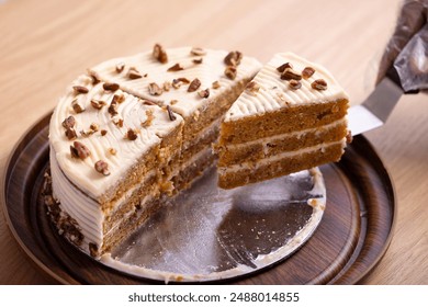 Delicious Slice of Carrot Cake with Cream Cheese Frosting. A mouth-watering close-up of a slice of carrot cake with rich cream cheese frosting. The cake is beautifully layered with moist, carrot - Powered by Shutterstock