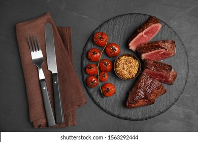 Delicious Sliced Beef Tenderloin Served On Black Table, Top View