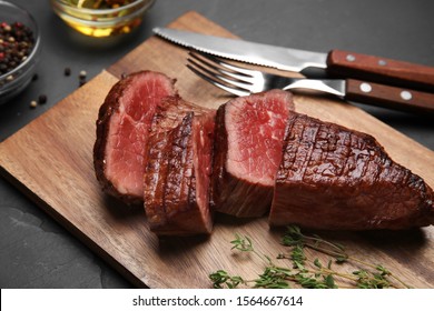 Delicious sliced beef tenderloin served on table, closeup - Shutterstock ID 1564667614