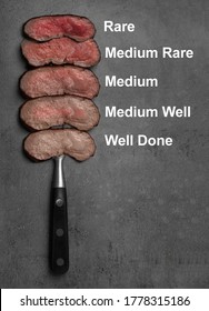 Delicious sliced beef tenderloins with different degrees of doneness on grey background, top view 