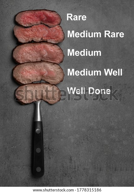 Delicious sliced beef tenderloins\
with different degrees of doneness on grey background, top view\
