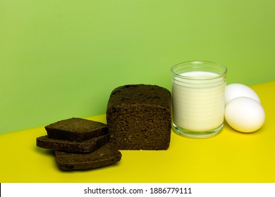 Delicious Sliced Bread, A Glass Of Fresh Milk, Boiled Eggs On A Yellow And Green Background. Healthy Food Concept. Foods You Can Eat On A Bland Diet. Copy Space.