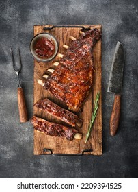 Delicious smoked pork ribs glazed in BBQ sauce. Top view.