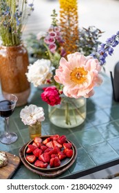 Delicious Snack On Garden Table Decorated With Different Flowers At Backyard