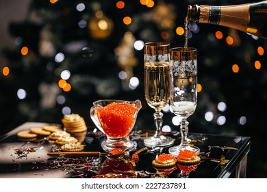 Delicious snacks with cream cheese and red caviar with glass of champagne, Festive drink. Valentins or Christmas concept. - Shutterstock ID 2227237891