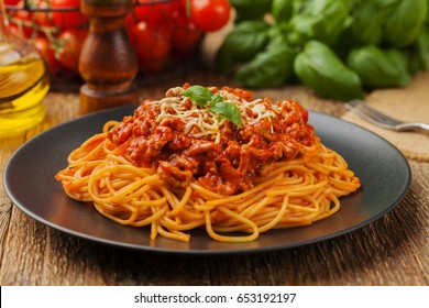 Delicious spaghetti served on a black plate - Shutterstock ID 653192197