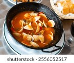 Delicious Spanish Tapas Almejas a la marinera - shellfish broth with vegetables