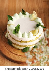 Delicious spicy lime green gradient cake and mint   spinach  Lemon cake the table March 8  Mother's Day  Valentine's Day birthday  Wooden background  citrus sliced   flowers  Copy space 