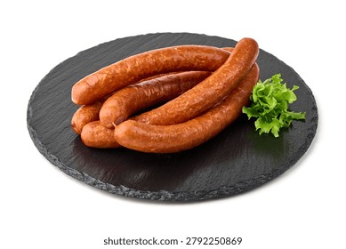 A delicious stack of grilled sausages is presented on a rustic black slate plate, garnished with fresh green lettuce, perfect for a hearty meal.