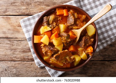 delicious stew estofado with beef and vegetables in a bowl close-up. Horizontal top view from above