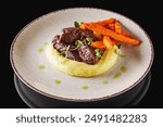 delicious stewed beef cheeks on mashed potatoes.