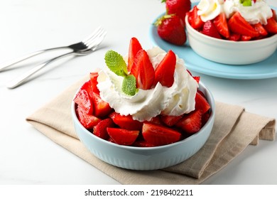 Delicious strawberries with whipped cream served on white table - Powered by Shutterstock