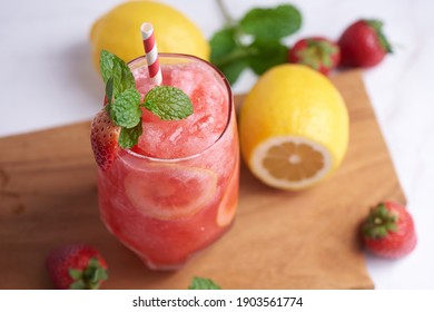 Delicious Strawberry And Lemon Smoothie Garnished With Fresh Strawberry And Mint In Glass. Soft Focus. Beautiful Appetizer Pink Strawberry, Well Being And Weight Loss Concept.