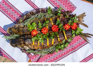 Delicious stuffed carp with lemon, tomato and herbs, close up, Ukraaine