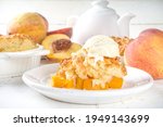  Delicious Summer Peach Cobbler, Homemade sweet summer pie with peaches and vanilla ice cream on white wooden background copy space