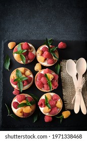 Delicious summer tartlets with raspberries and yoghurt. Yellow and red raspberries. Healthy dessert. Keto dessert. - Shutterstock ID 1971338468