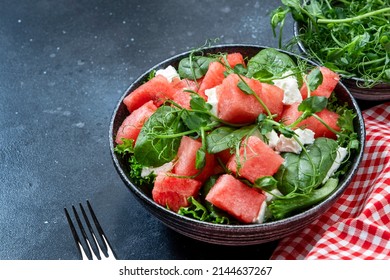 Delicious Summer Watermelon Salad Bowl With Feta Cheese, Spinach And Pea Sprouts On Gray Table Background, Top View, Negative Space