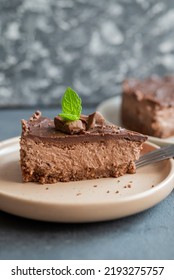 Delicious Sweet Chocolate Cake Cheesecake In A Restaurant Mint Leaf On A Plate