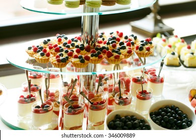 Delicious sweet cupcakes and pastry at wedding  dessert table reception