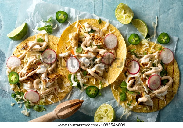 Delicious\
tacos with grilled fish, cilantro, lime, cabbage, carrot, jalapeno\
and radish with mexican chili crema\
sauce.