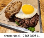 Delicious tasty beef burger hamburger with fresh egg topping isolated symbol of american food cuisine full of protein and carbs for a non dietary healthy body builder protein carbs food diet